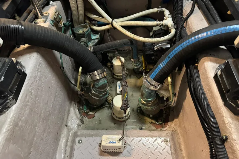  Yacht Photos Pics Engine compartment of a 2003 Sea Ray 480 Sedan Bridge with visible hoses and fittings.