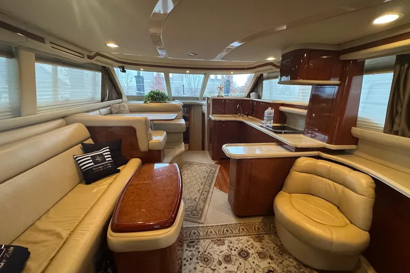  Yacht Photos Pics Luxurious interior of 2003 Sea Ray 480 Sedan Bridge yacht with elegant seating and kitchen area.