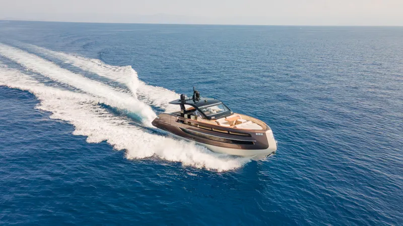  Yacht Photos Pics 2025 Invictus TT550 yacht cruising on open sea, creating dynamic water trails.