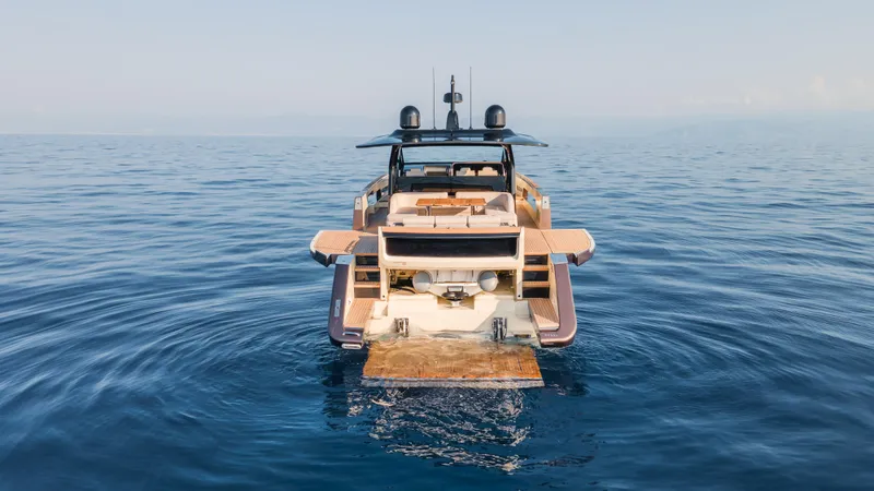  Yacht Photos Pics 2025 Invictus TT550 yacht on calm ocean waters, rear view.
