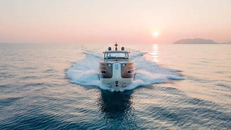  Yacht Photos Pics Invictus TT550 yacht cruising at sunset, 2025 model, serene ocean view.
