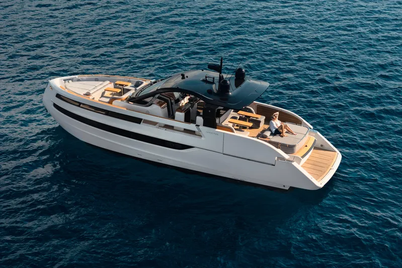  Yacht Photos Pics 2025 Invictus TT550 yacht cruising on open blue sea, featuring sleek modern design.