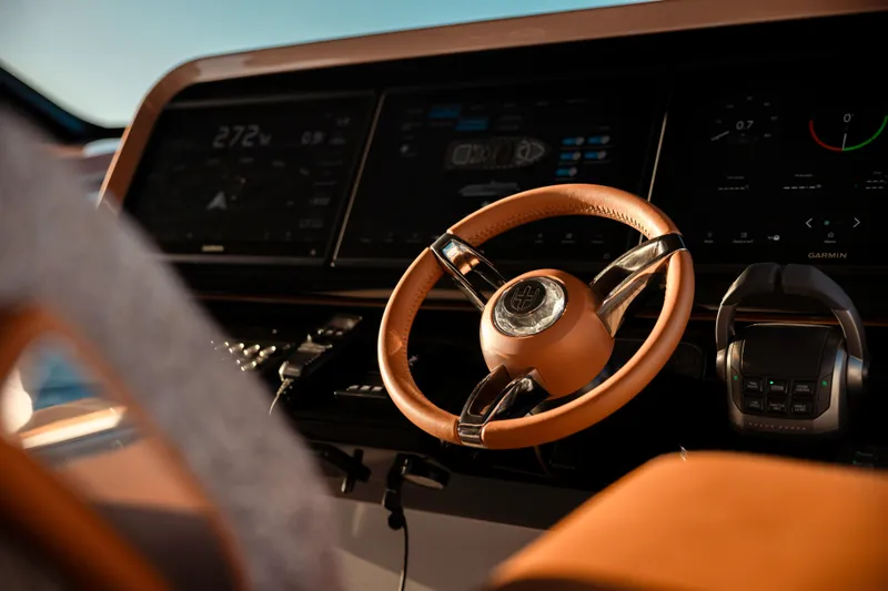  Yacht Photos Pics Steering wheel and dashboard of 2025 Invictus TT550 yacht, featuring advanced controls.