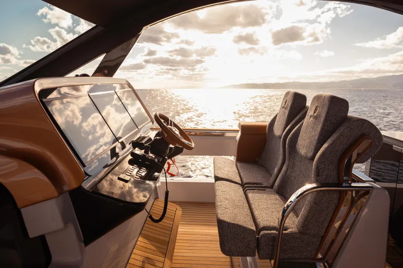  Yacht Photos Pics Luxurious 2025 Invictus TT550 yacht interior with plush seating and ocean view.