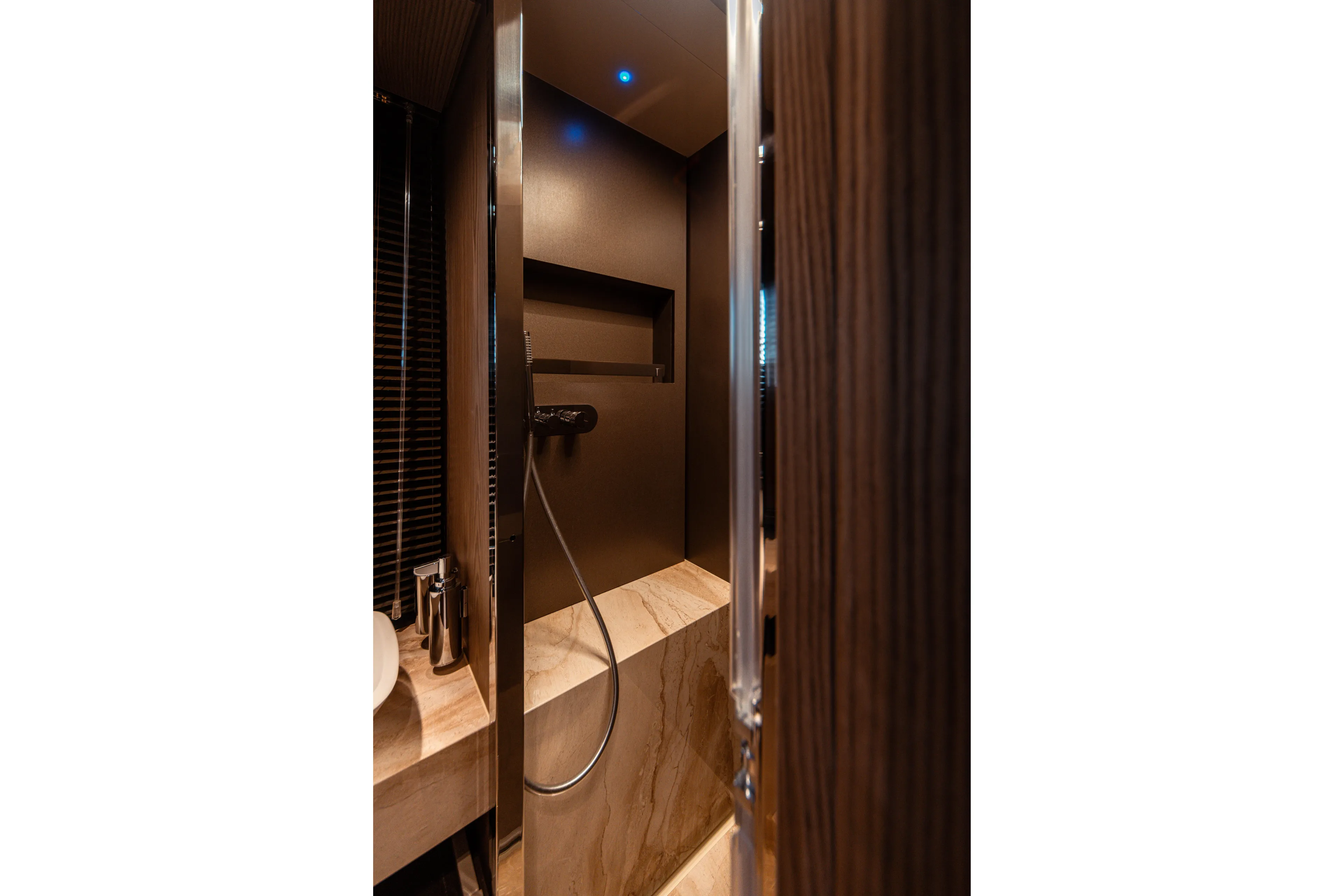  Yacht Photos Pics Luxurious bathroom interior of 2025 Invictus TT550 yacht with modern shower design.