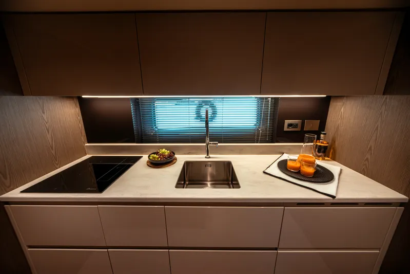  Yacht Photos Pics Modern kitchen interior in 2025 Invictus TT550 yacht with sleek design and amenities.