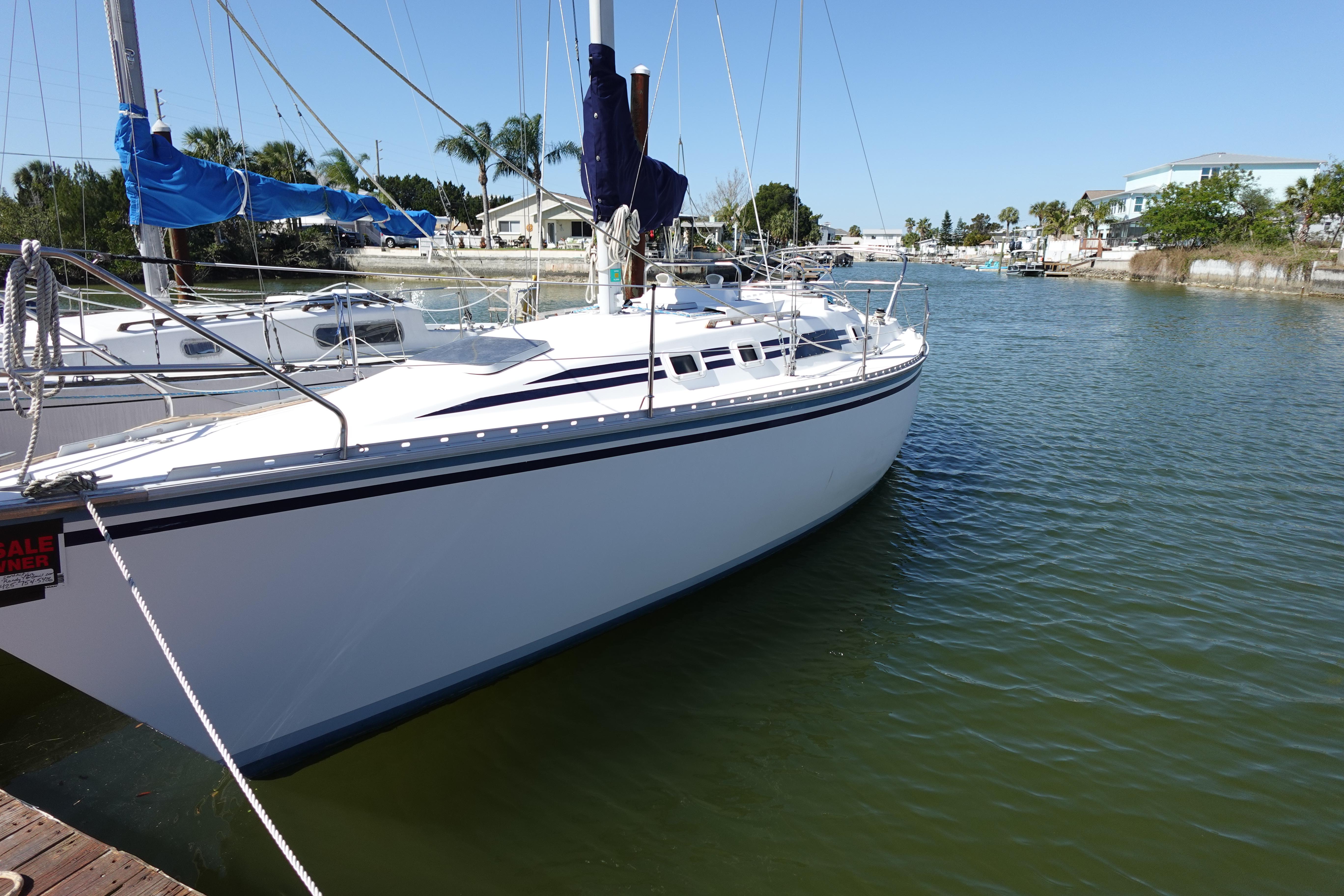 1987 Hunter 310 sailboat docked in a serene marina setting.