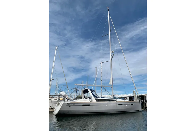 V-1 Yacht Photos Pics 2018 Beneteau Oceanis 45 sailboat docked under a clear blue sky.