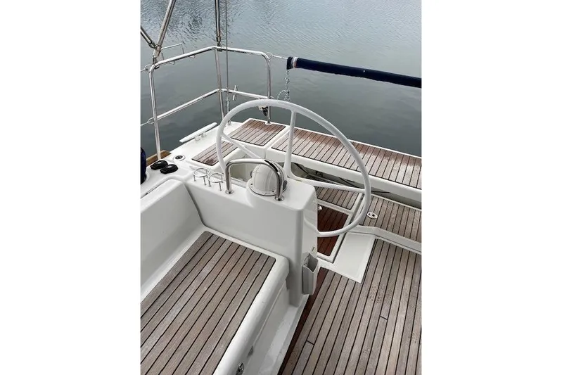 V-1 Yacht Photos Pics Cockpit of 2018 Beneteau Oceanis 45 sailboat with wooden deck and steering wheel.