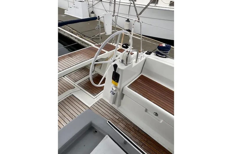 V-1 Yacht Photos Pics 2018 Beneteau Oceanis 45 yacht cockpit with wooden deck and steering wheel.
