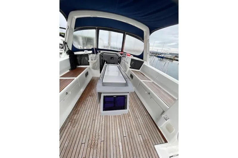 V-1 Yacht Photos Pics 2018 Beneteau Oceanis 45 yacht cockpit with teak flooring and blue canopy.