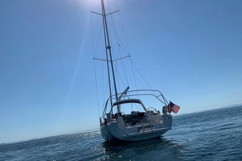 V-1 Yacht Photos Pics 2018 Beneteau Oceanis 45 sailboat on calm sea under clear blue sky.