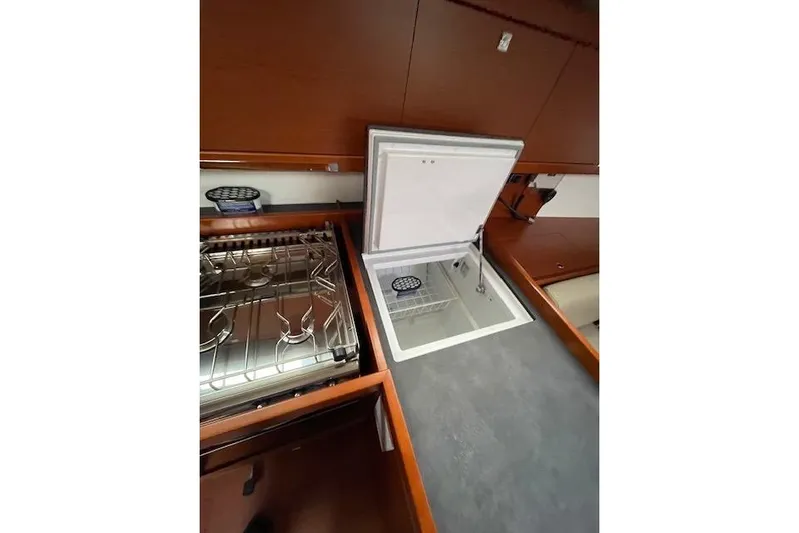 V-1 Yacht Photos Pics 2018 Beneteau Oceanis 45 yacht kitchen with stove and open fridge.