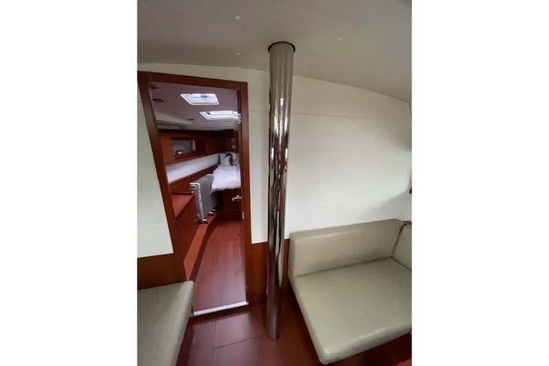 V-1 Yacht Photos Pics Interior of 2018 Beneteau Oceanis 45 yacht, featuring cozy seating and a cabin view.