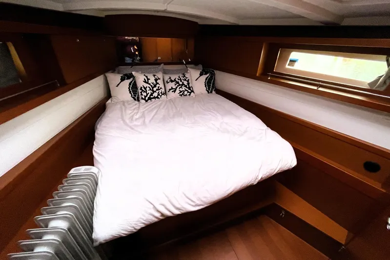 V-1 Yacht Photos Pics Cozy cabin interior of 2018 Beneteau Oceanis 45 yacht with bed and window.