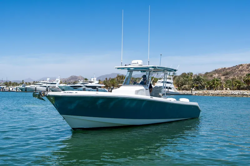 Carnal Yacht Photos Pics 2020 Edgewater 320CC boat on calm water with clear blue sky.