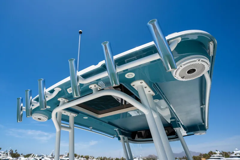 Carnal Yacht Photos Pics Edgewater 320CC 2020 boat's T-top with rod holders against clear blue sky.