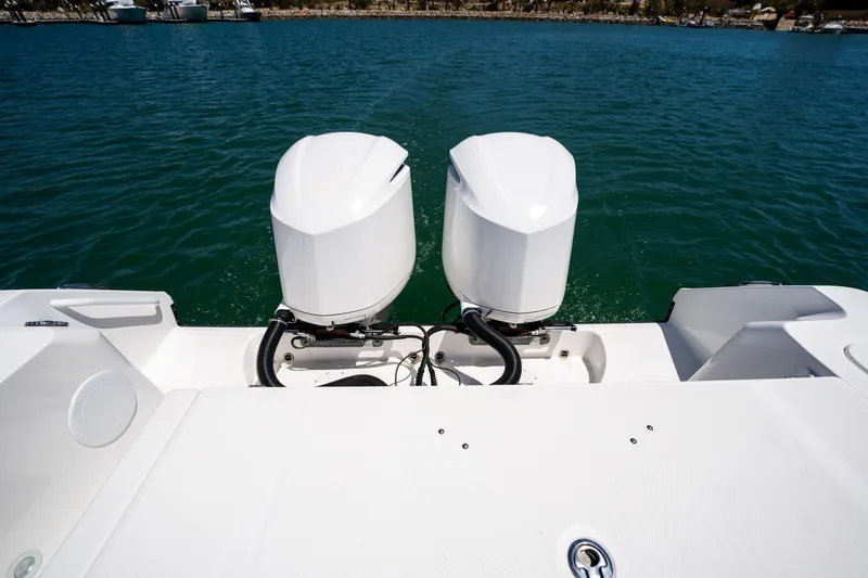 Carnal Yacht Photos Pics Edgewater 320CC 2020 boat with dual outboard motors on calm water.