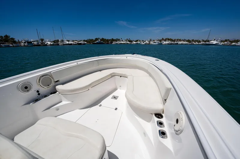 Carnal Yacht Photos Pics Edgewater 320CC 2020 boat interior with white seating, on calm blue water.