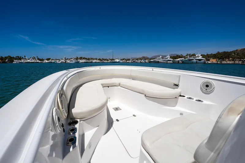 Carnal Yacht Photos Pics 2020 Edgewater 320CC boat interior with white seating, on a sunny day by the water.