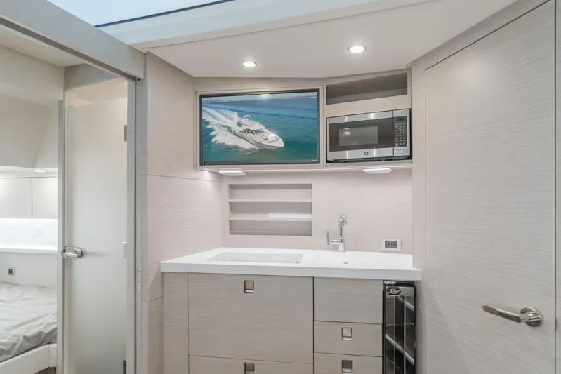 Mandalorian Yacht Photos Pics Luxurious interior of 2023 Scout 530 LXF yacht with modern kitchenette and TV.