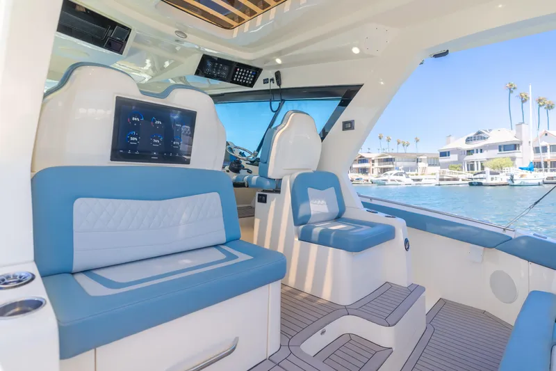Mandalorian Yacht Photos Pics Interior of 2023 Scout 530 LXF yacht with blue seating and digital display.