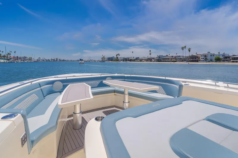 Mandalorian Yacht Photos Pics 2023 Scout 530 LXF luxury boat interior with waterfront view, featuring elegant seating and tables.