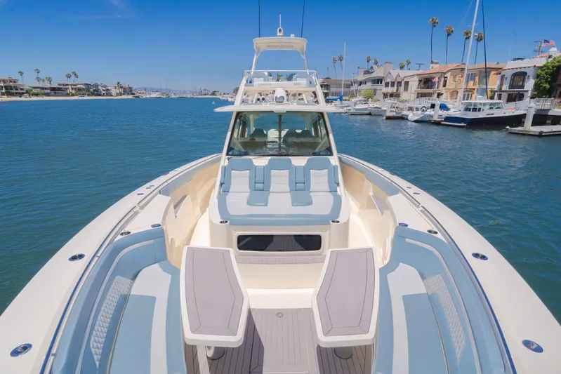 Mandalorian Yacht Photos Pics 2023 Scout 530 LXF luxury boat docked in a scenic marina setting.