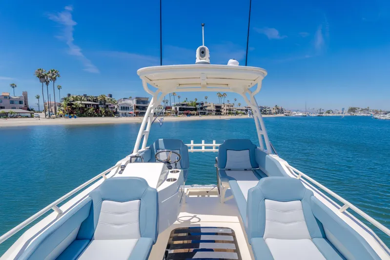 Mandalorian Yacht Photos Pics 2023 Scout 530 LXF luxury boat interior with ocean view and coastal backdrop.