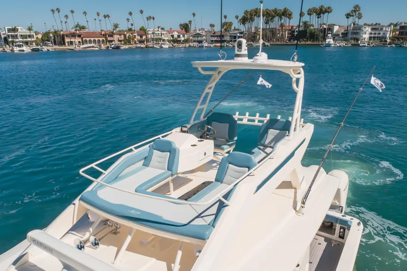 Mandalorian Yacht Photos Pics 2023 Scout 530 LXF luxury boat cruising near waterfront homes and palm trees.