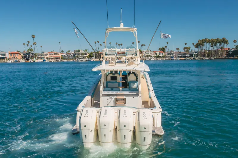 Mandalorian Yacht Photos Pics 2023 Scout 530 LXF luxury boat cruising in a scenic waterfront setting.