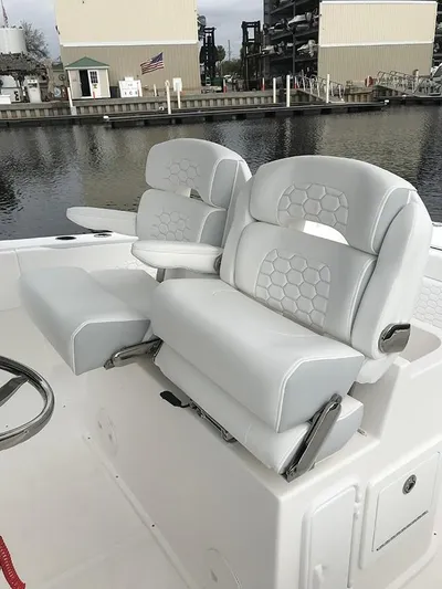 New Boat Yacht Photos Pics 2023 Stamas 31T Aventura boat with luxurious white seating by the dock.