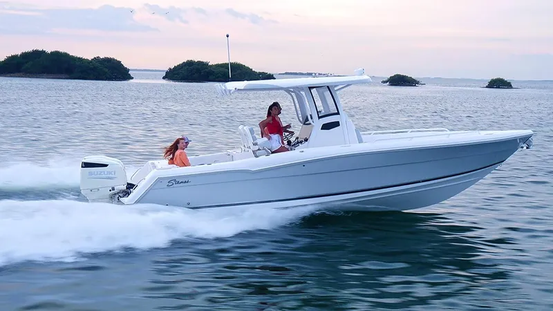 New Boat Yacht Photos Pics 2023 Stamas 31T Aventura boat cruising on open water at sunset.