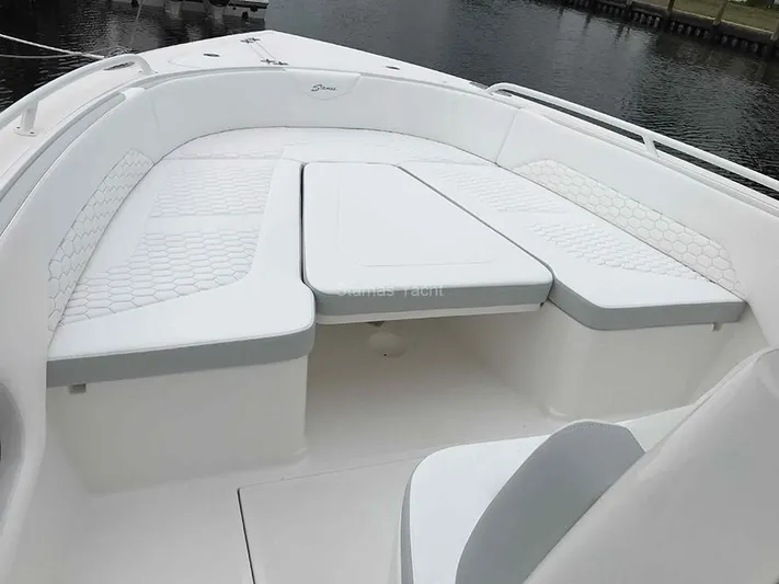 New Boat Yacht Photos Pics 2023 Stamas 31T Aventura boat with white cushioned seating on deck.