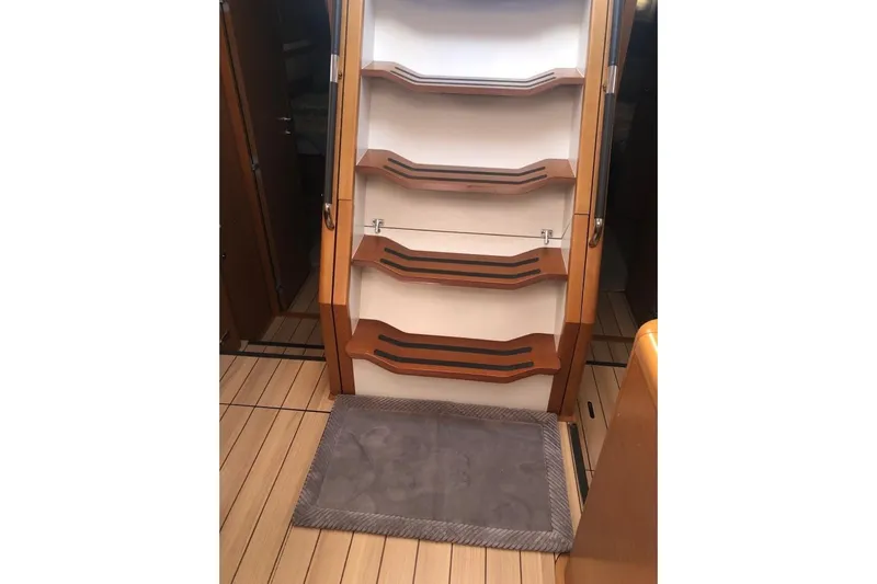  Yacht Photos Pics Interior stairs of a 2015 Jeanneau 57 yacht with wooden finish.