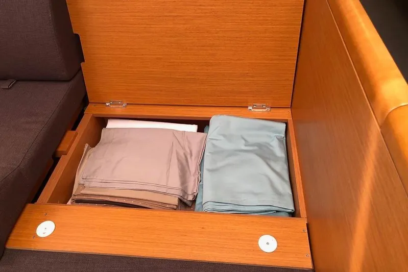  Yacht Photos Pics Storage compartment with folded linens on a 2015 Jeanneau 57 yacht.