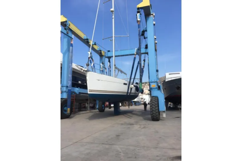  Yacht Photos Pics 2015 Jeanneau 57 yacht being lifted by a blue boat hoist.