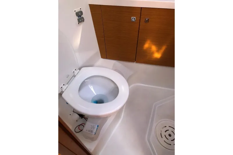  Yacht Photos Pics 2015 Jeanneau 57 yacht bathroom with modern toilet and wooden cabinetry.