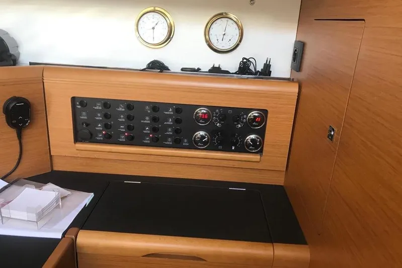  Yacht Photos Pics Control panel of a 2015 Jeanneau 57 yacht with wooden finish and gauges.