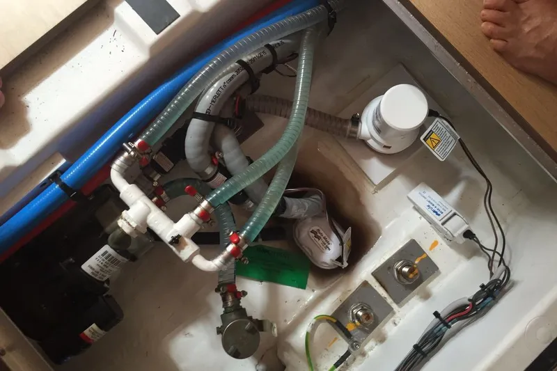  Yacht Photos Pics Bilge area of a 2015 Jeanneau 57 sailboat with plumbing and wiring components.
