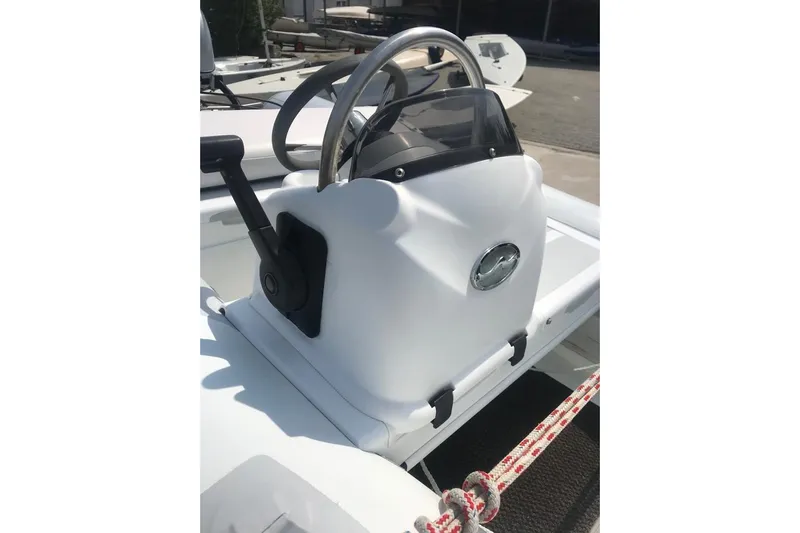  Yacht Photos Pics Steering console of a 2015 Jeanneau 57 yacht, featuring a sleek design and control lever.