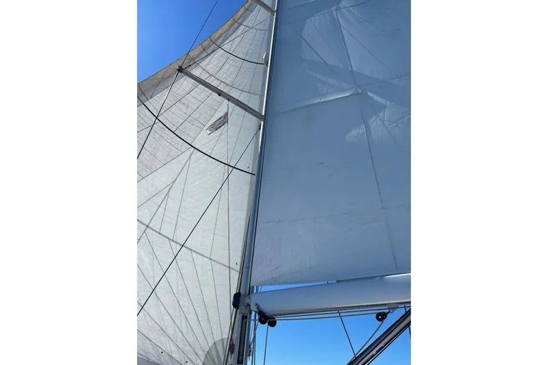  Yacht Photos Pics Sails of a 2015 Jeanneau 57 yacht against a clear blue sky.