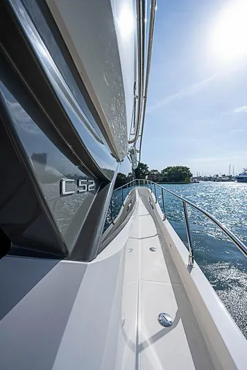  Yacht Photos Pics 2017 Carver C52 Coupe yacht on sunny water, showcasing sleek design and luxury.