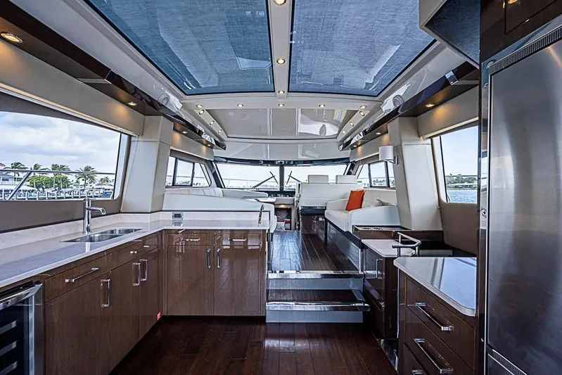  Yacht Photos Pics Luxurious interior of 2017 Carver C52 Coupe yacht with modern kitchen and seating area.