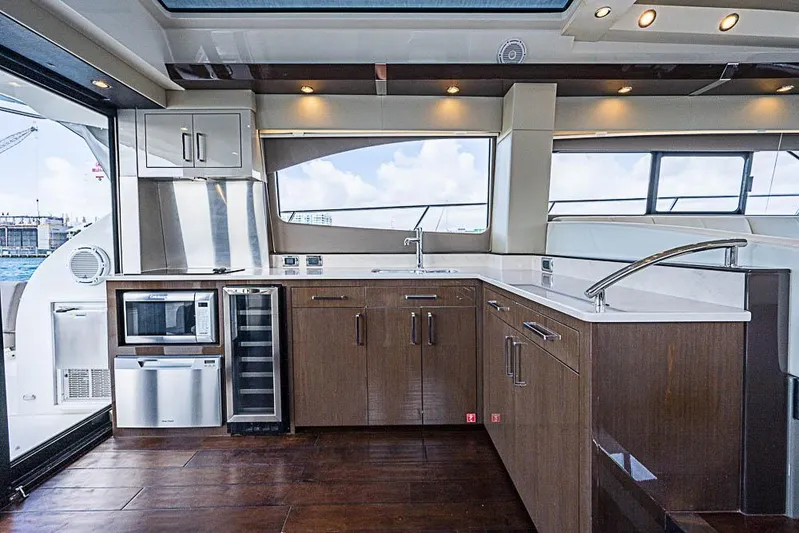  Yacht Photos Pics Luxurious kitchen interior of 2017 Carver C52 Coupe yacht with modern appliances and sleek design.