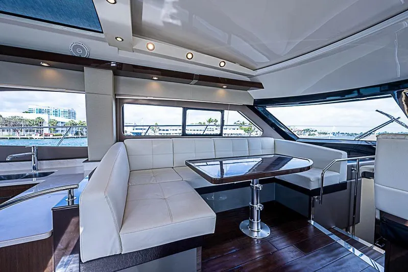  Yacht Photos Pics Luxurious interior of 2017 Carver C52 Coupe yacht with elegant seating and panoramic windows.