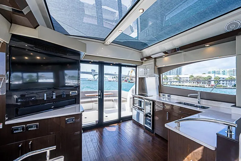  Yacht Photos Pics Luxurious interior of 2017 Carver C52 Coupe yacht with modern kitchen and large windows.