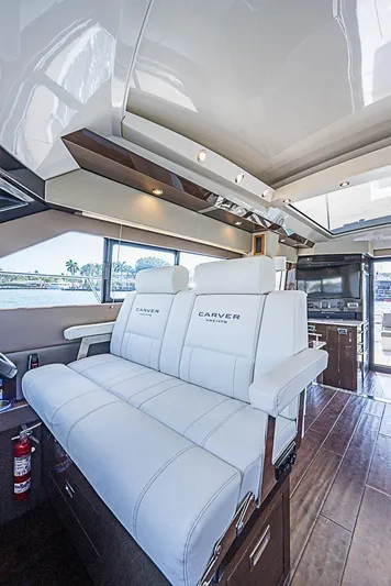  Yacht Photos Pics Luxurious interior of 2017 Carver C52 Coupe yacht with plush white seating.