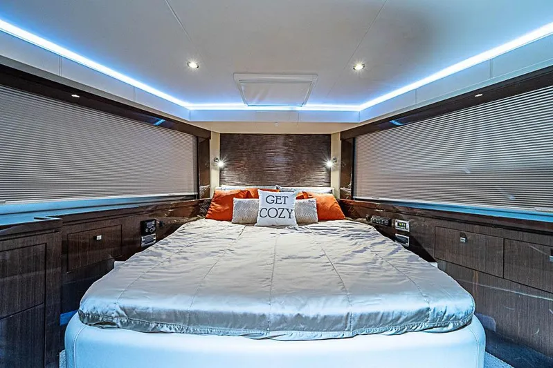  Yacht Photos Pics Luxurious bedroom interior of 2017 Carver C52 Coupe yacht with cozy bedding and ambient lighting.