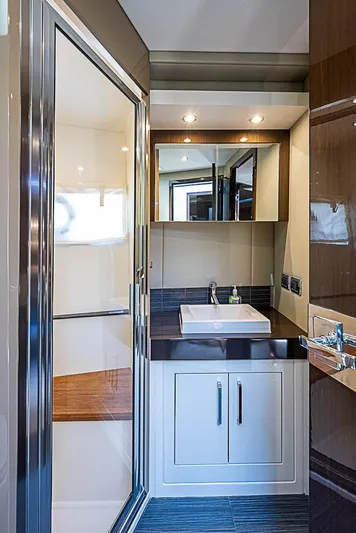  Yacht Photos Pics Luxurious bathroom interior of 2017 Carver C52 Coupe yacht with modern fixtures and sleek design.